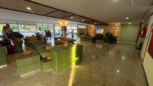 a lobby with green furniture in a building at Gran Solare Flat Residence - Mandacaru 505 in Barreirinhas +17 photos