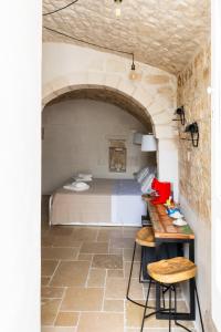 a bedroom with a bed and a table in a room at Atagio luxury room in Ostuni +54 photos