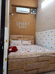 a bedroom with a bed with a smart room sign on the wall at SIDHU GUEST HOUES 5 minute walking distance golden Temple in Amritsar
