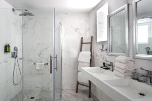 a white bathroom with a sink and a shower at Hotel La Villa Nice Promenade in Nice +59 photos