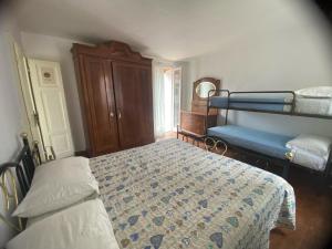 a bedroom with two bunk beds and a blue bed at Foresteria Lombarda B & B Ca' Pelitti in Ganna
