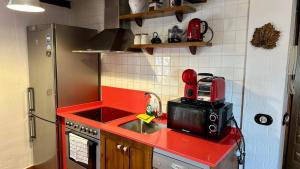 a small kitchen with a sink and a microwave at Apartamento Santo Domingo in Cuenca +4 photos