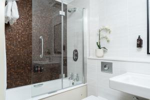 a bathroom with a shower and a sink at Royal Berkshire in Ascot