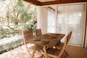 a dining room table with chairs and a large window at Maison du Parc - Vue canal in Hossegor