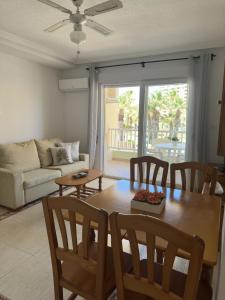 a living room with a table and chairs and a couch at Ipanema 52 - La Manga By WATERMELON in La Manga del Mar Menor