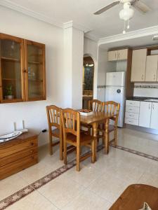a kitchen and dining room with a table and chairs at Ipanema 52 - La Manga By WATERMELON in La Manga del Mar Menor