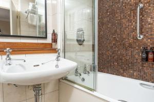 a bathroom with a sink and a shower at Royal Berkshire in Ascot