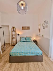 a bedroom with a bed with a blue comforter at Family Room in Nice +7 photos