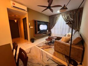 a living room with a couch and a tv at AS Homestay Gamuda Gardens Gaia Residence 2R1B Rawang Skyline Luge in Rawang