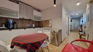 a kitchen with a table and chairs in a room at L&B House in Malbork