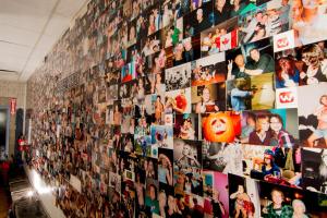 a wall full of pictures on a wall at Wicked Hostels - Calgary in Calgary