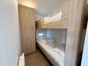 a bedroom with two bunk beds in a room at Chalet 501b op Recreatiepark De Wielen in Sint Maarten +19 photos