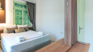 a bedroom with a bed with towels on it at Paleochora Central Apartments in Palaiochóra