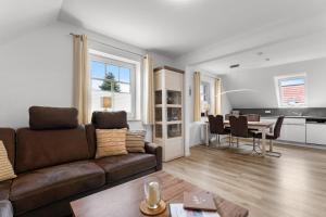 a living room with a couch and a table at Schonergang Greetje Oog in Krummhörn +12 photos