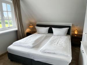Ένα ή περισσότερα κρεβάτια σε δωμάτιο στο Landhaus am Watt