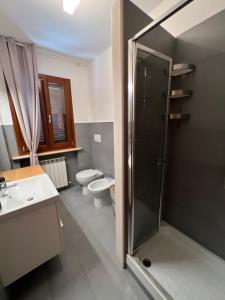 a bathroom with a shower and a sink and a toilet at Casa Nilù in Civitanova Marche