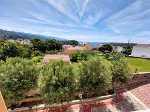 a view from the roof of a house with trees at Apartments Palit in Rab
