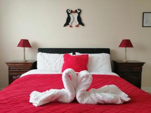 two swans made out of towels on a bed at Puffin rooms in Lisdoonvarna