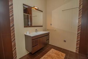 a bathroom with a sink and a mirror at Casa do Douro& Porto in Lousada +20 photos