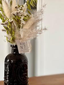 a vase with flowers in it sitting on a table at L'Opéra, hyper centre de Rennes in Rennes