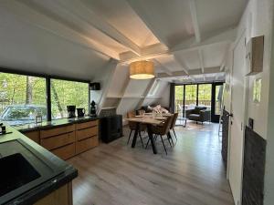 a kitchen and living room with a table and chairs at Chalet 23 in Durbuy