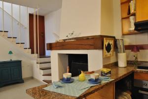 a living room with a table with a fireplace at La Casa sul Lago in Angera
