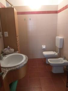 a bathroom with a sink and a toilet at La Casa sul Lago in Angera +36 photos
