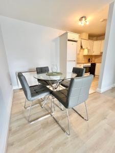 a glass table and chairs in a living room at Dublin City Apartment - 2 bedrooms in Dublin +3 photos