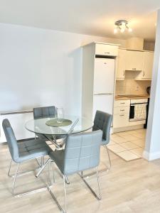 a dining room with a glass table and chairs at Dublin City Apartment - 2 bedrooms in Dublin