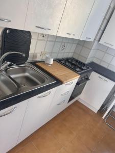 a kitchen with a sink and a stove at Al Capitello in Lacco Ameno