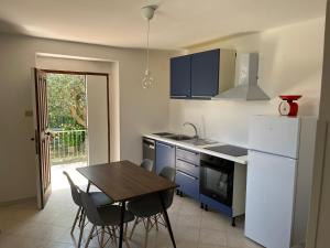 a kitchen with a table and chairs and a refrigerator at Camasileo in Ortona +23 photos