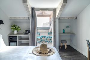 a bedroom with a bed with a hat on it at Hotel La Villa Nice Promenade in Nice