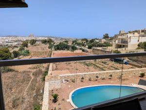 d'un balcon avec vue sur la piscine. dans l'établissement Brand New Ta' Cenc Apartment, à Sannat 2 autres photos