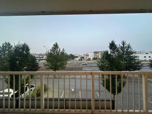 a balcony with a view of a parking lot at Design Prishtina Apartment 1 in Pristina