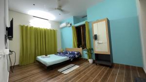 a hospital room with a bed and a mirror at Alchemist Villa-Kazhakootam in Trivandrum