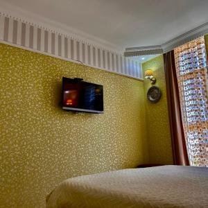 a bedroom with a flat screen tv on the wall at Apartment Orbi Sea Tower David in Batumi