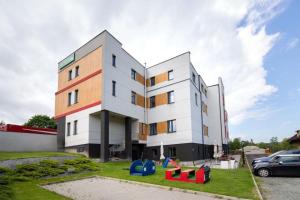 un bâtiment avec des équipements de jeux colorés devant lui dans l'établissement NiMFa THE BEST - EXLUSIVE 10, à Kudowa-Zdrój