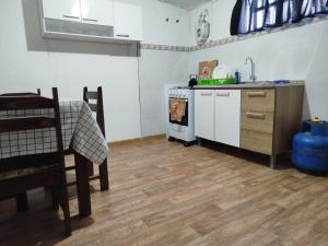 a kitchen with a stove and a sink and a table at Apartamento centro young in Young