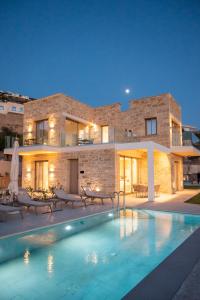 a villa with a swimming pool in front of a building at Falasarna's Dream in Kissamos