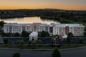 an aerial view of a building with a river at Hampton Inn & Suites Huntsville Research Park Area in Huntsville
