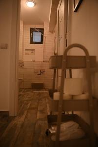 a bathroom with a shower and a chair in a room at Arin l Aparthotel #1 in Craiova