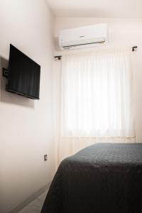 a bedroom with a bed and a tv and a window at Summerhouse Blanka 2024 in Vir +45 photos