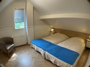 a bedroom with a bed and a chair and a window at HAVRE DE PAIX si près de PARIS et JO 2024 in Férolles-Attilly