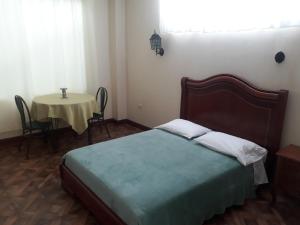 Postel nebo postele na pokoji v ubytování El Cardenal Hotel
