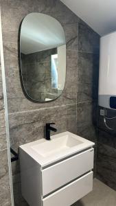 a bathroom with a white sink and a mirror at STYLISH STUDIO APARTMENT BURE in Murter +7 photos