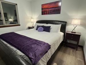 a bedroom with a large bed with a purple blanket at Fun House #265 w Water Park & Golf Cart in Arnolds Park +26 photos