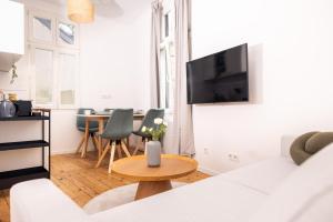 Una sala de estar con un sofá blanco y una mesa. en Design Suite! Familie - Küche - Zentral, en Wuppertal