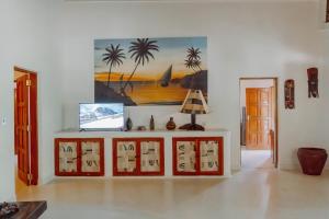 a living room with a painting on the wall at Baobab Village in Watamu