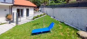 una silla azul sentada en el césped en un patio en Eden 4, en Ornavasso