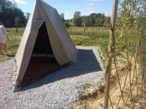 a tent is set up on a pile of gravel at Scout-1 in Le Fay
